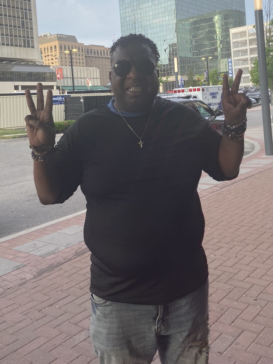 Danny Lawrence, founder of A Hard Act to Follow, in downtown St. Louis with the Gateway Arch behind him